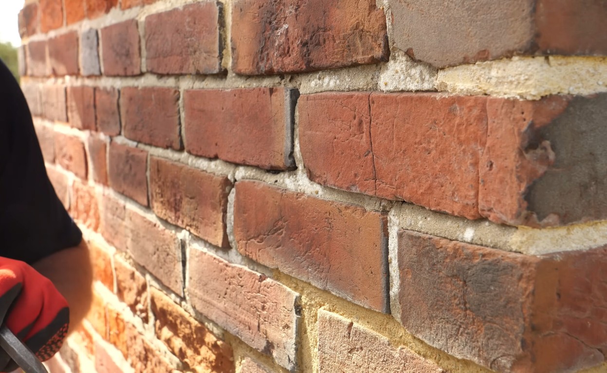 Expert brick repair and restoration services showing cracked brick wall assessment in Oceanside, CA